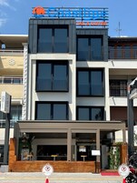 A modern building with a sign reading "Coastline Tail & Coffee".