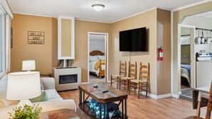 A cozy living room with a sofa, a coffee table, a TV, and a fireplace. - Choteau Vacation Rental w/ Yard: Walk to Downtown! (Choteau)
