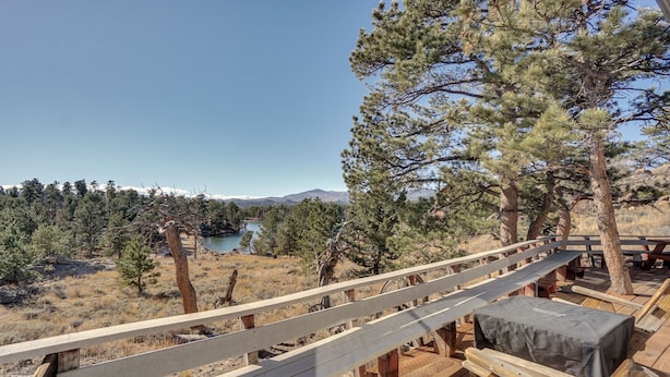 A wooden deck with benches overlooking a natural landscape with trees and a body of water. - Red Feather Lakes Cabin w/ Deck & Views! (Red Feather Lakes)