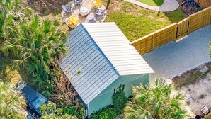 A residential property with a swimming pool, a deck, and a small lawn area. - Historic district- yard, putting green, firepit (Saint Augustine)