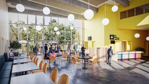 Un espacio interior amplio con techos altos, ventanas grandes y una variedad de disposiciones de asientos, incluyendo mesas y sillas.