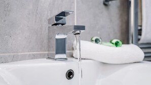 A bathroom sink with a modern faucet and a towel. - Host & Stay | The Georgian Quarters at Canning III (Liverpool)
