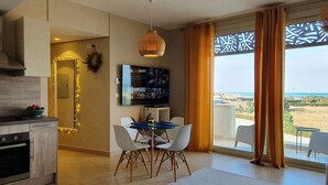 A modern kitchen with a dining area, a television, and a view of the sea. - El Gouna - Sea view - Kitesurfing  (Hurghada)