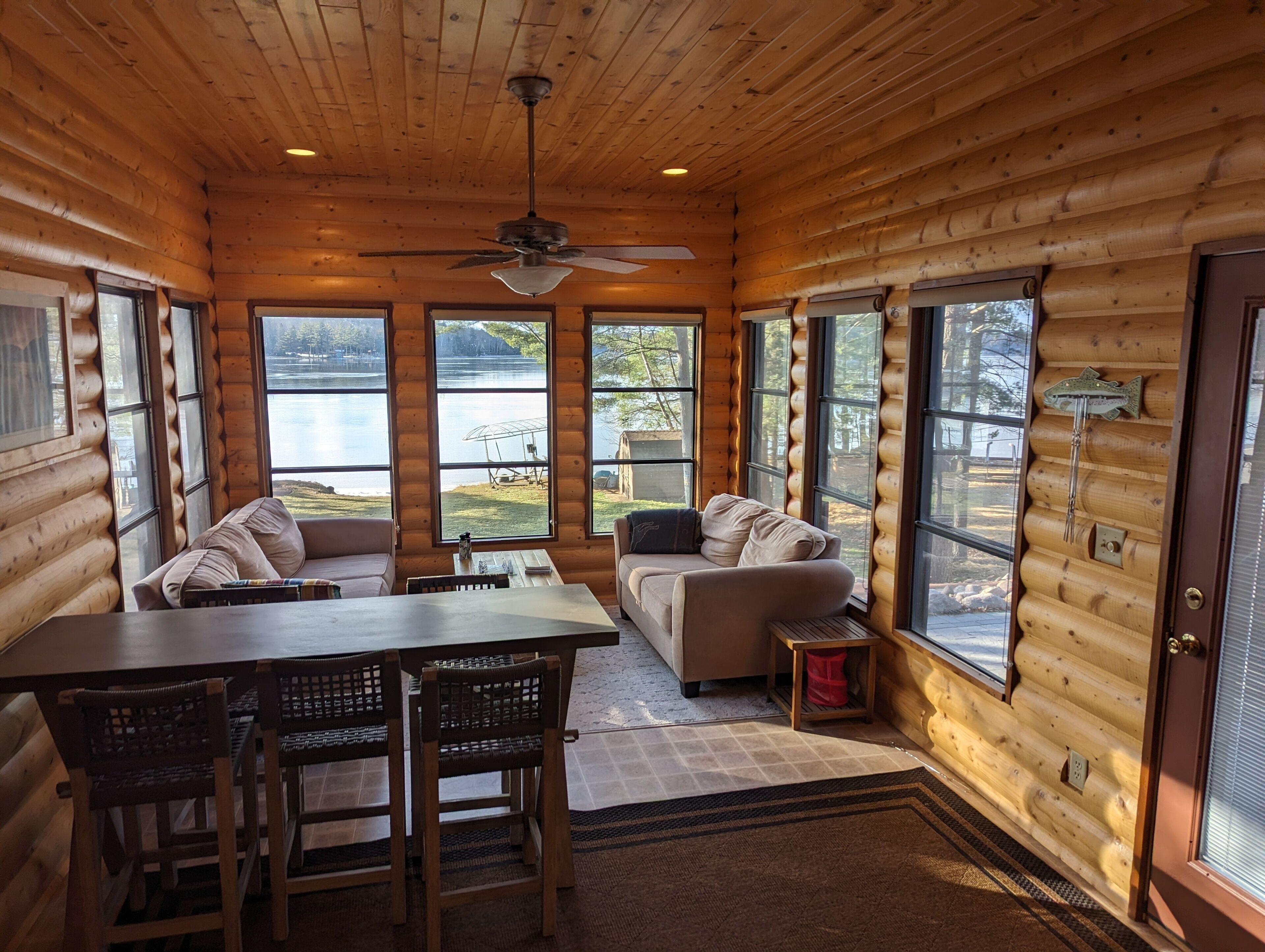 Sunroom with game table and  beautiful lake views!