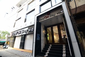 A hotel entrance with a sign reading "Hotel OM Stay We". - Hotel Om Stay Well (Indore)