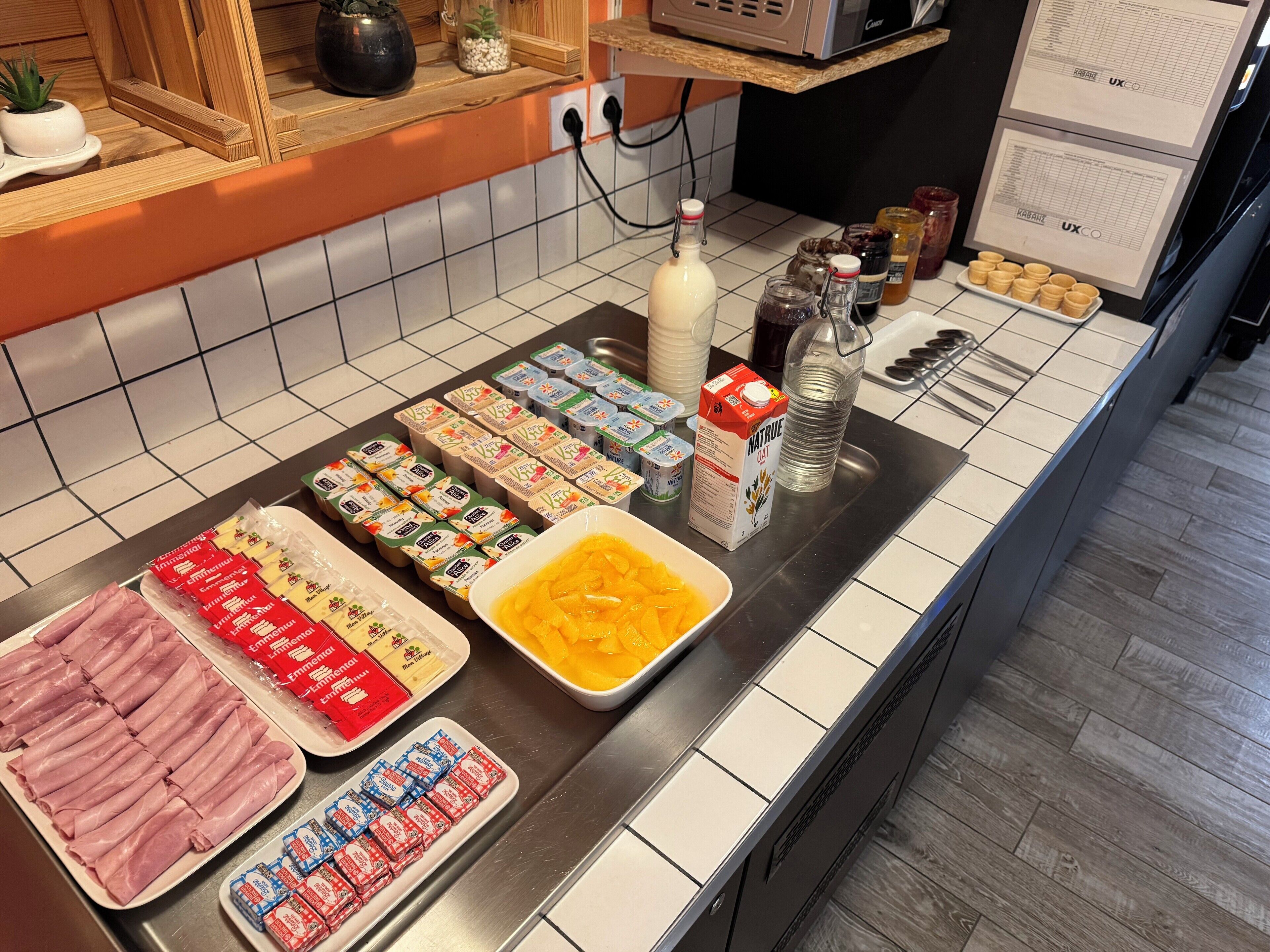 A breakfast buffet with various food items and condiments.