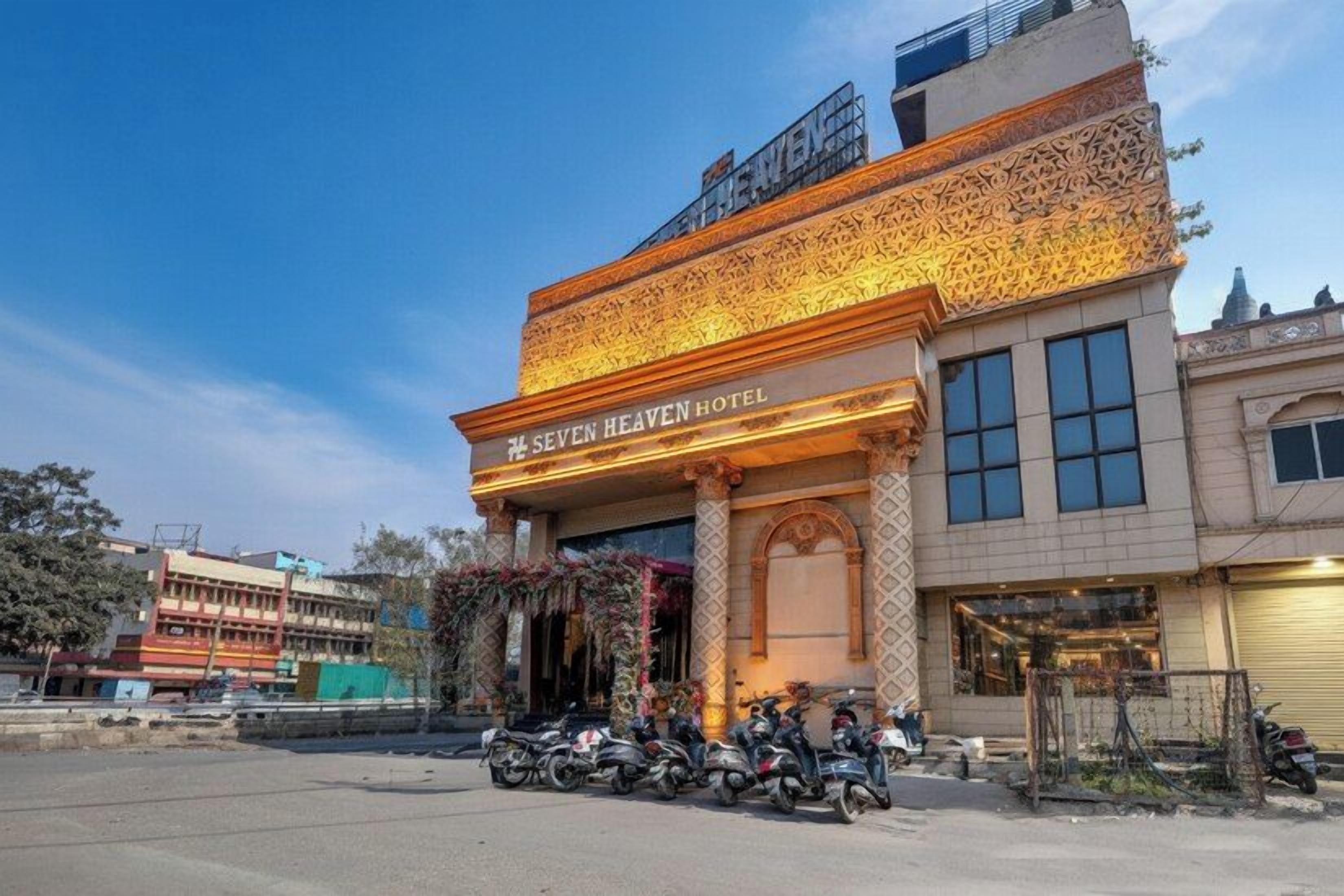 A hotel with a prominent entrance, a balcony, and a sign indicating it is the 'SEVEN HEAVEN HOTEL'.