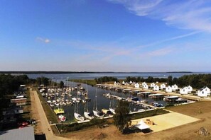 Stunning marina views with boats docked in calm waters, surrounded by lush greenery and a serene body of water.