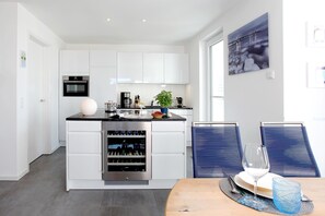Enjoy cooking and dining in this well-equipped kitchen with wine cooler, dining area and artistic touches.