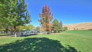 A park with a playground, trees, and a grassy field. - NorthEnd Charmer 1 bedroom Near BSU (Boise)