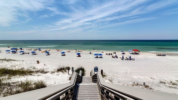 A beach with a wooden staircase leading down to the sand, numerous beach umbrellas, and a clear view of the ocean. - 2nd Floor Studio for 4, Pool, 300 Yds to the Beach + Free Attraction Tickets! (Santa Rosa Beach)