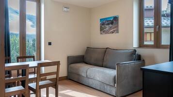 Family Room, Kitchenette | Living area | LED TV, books, first-run movies, heated floors