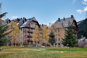 A multi-story building with a traditional architectural style, featuring multiple chimneys and balconies.