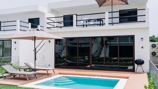 A modern two-story house with a swimming pool, outdoor seating, and a barbecue area. - NEW Bayfront Villa in Costa del Sol

 (El Zapote)