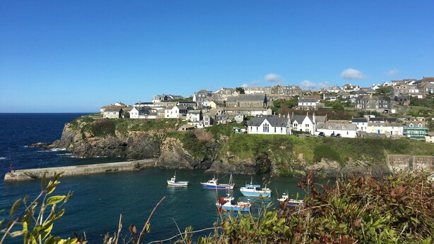 A coastal town with houses on a hillside overlooking the sea. - Tre Lowen (Port Isaac)