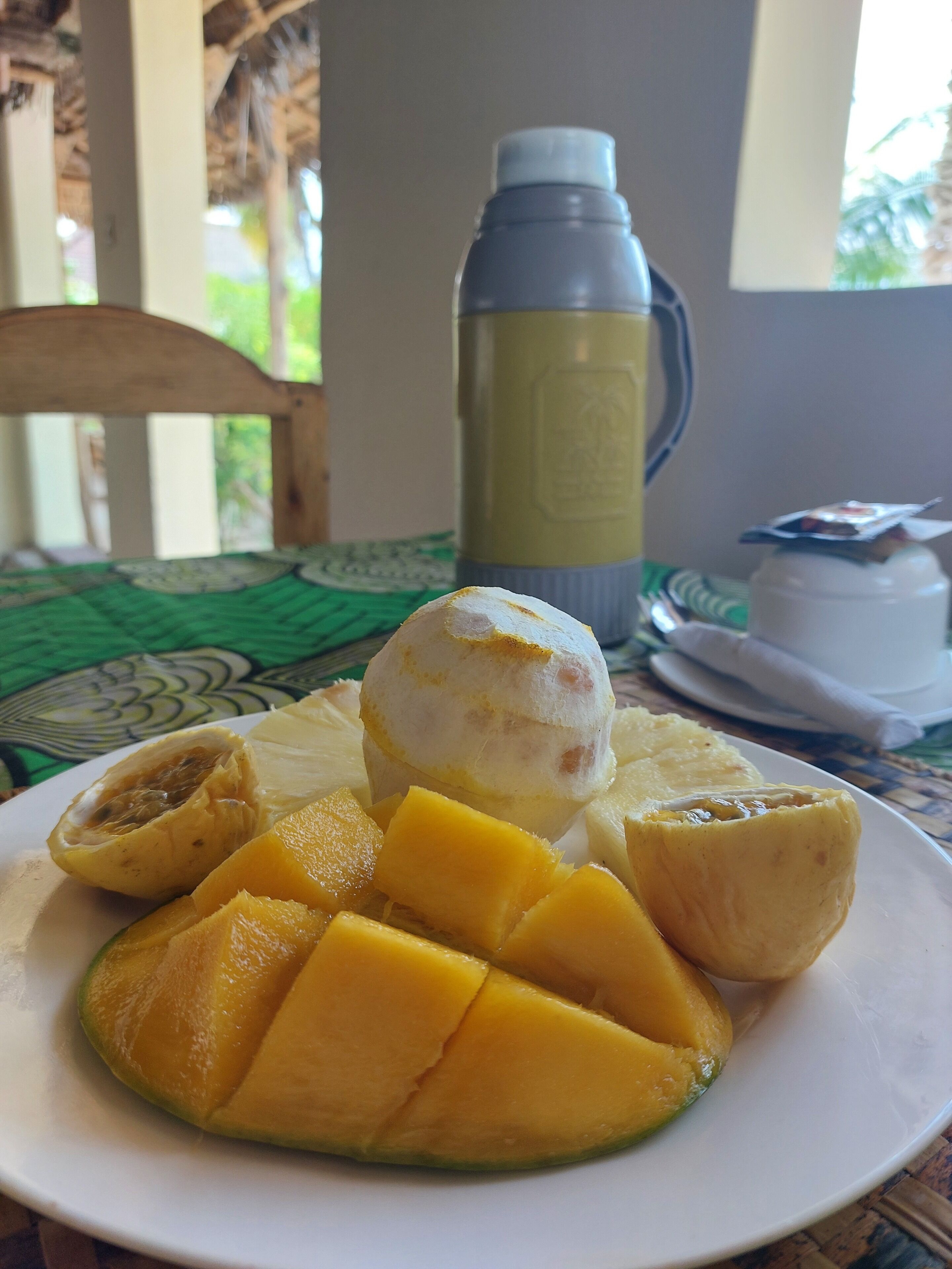 A plate with mango slices and a scoop of ice cream.
