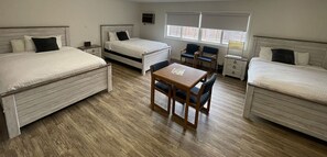 Deluxe Room 3 Queen Beds | Desk, laptop workspace, blackout drapes, iron/ironing board