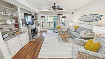 Smart TV, fireplace, books, computer monitors