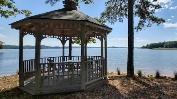A gazebo with a view of a lake.