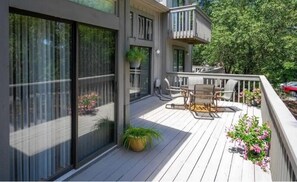 Enjoy the expansive balcony with a seating area, table, and potted plants.