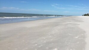 A wide beach with a clear sky and calm sea. - Heated Pool! 3min walk to the beach! Gorgeous Intercoastal Views!  (Indian Shores)