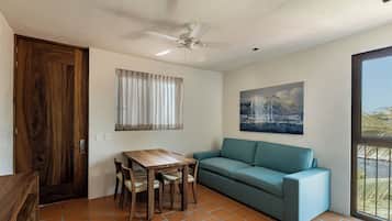 Deluxe Bungalow | Living area | 55-inch flat-screen TV with digital channels