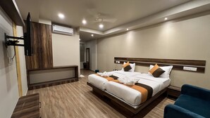 A modern hotel room with a large bed, a desk, and a chair.
