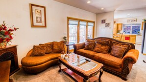 A living room with two sofas, a coffee table, and a fireplace.