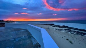 A coastal view with a sunset and a concrete pathway leading to the beach. - Sea La Vie - Schooner's Landing (Man-O-War Cay)