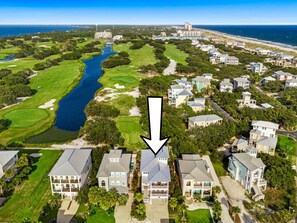 An aerial view of a coastal residential area with houses, a golf course, and a body of water. - Our Hangout house at Kiva Dunes (Gulf Shores)