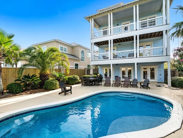 A two-story building with a pool, outdoor furniture, and a wooden fence. - Our Hangout house at Kiva Dunes (Gulf Shores)