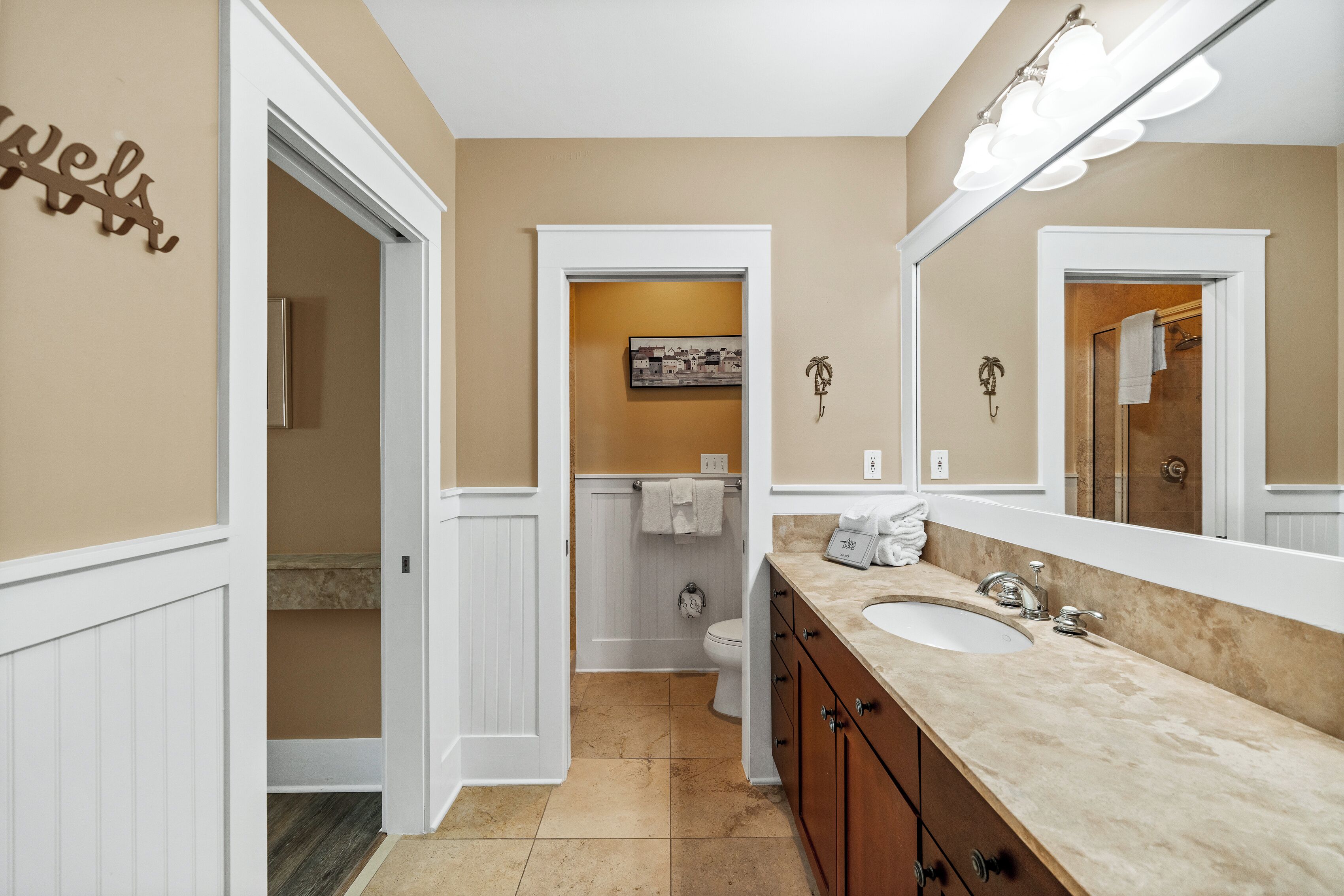 A bathroom with a vanity, sink, and mirror.