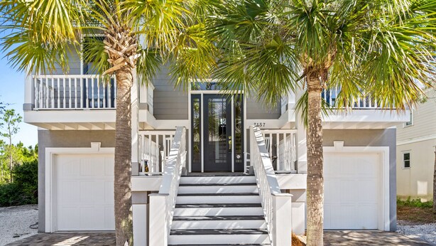 A two-story house with a front entrance, a staircase, and a garage. - Rising Tide house at Kiva Dunes -Book 7 nights, pay for 6!!- (Gulf Shores)