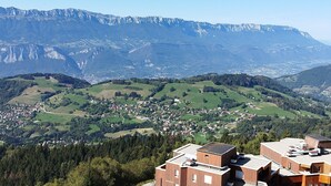 A mountainous landscape with a village in the valley. - 2-Room Apt at the Foot of the Slopes, Sleeps 5 (Les Adrets-Prapoutel)