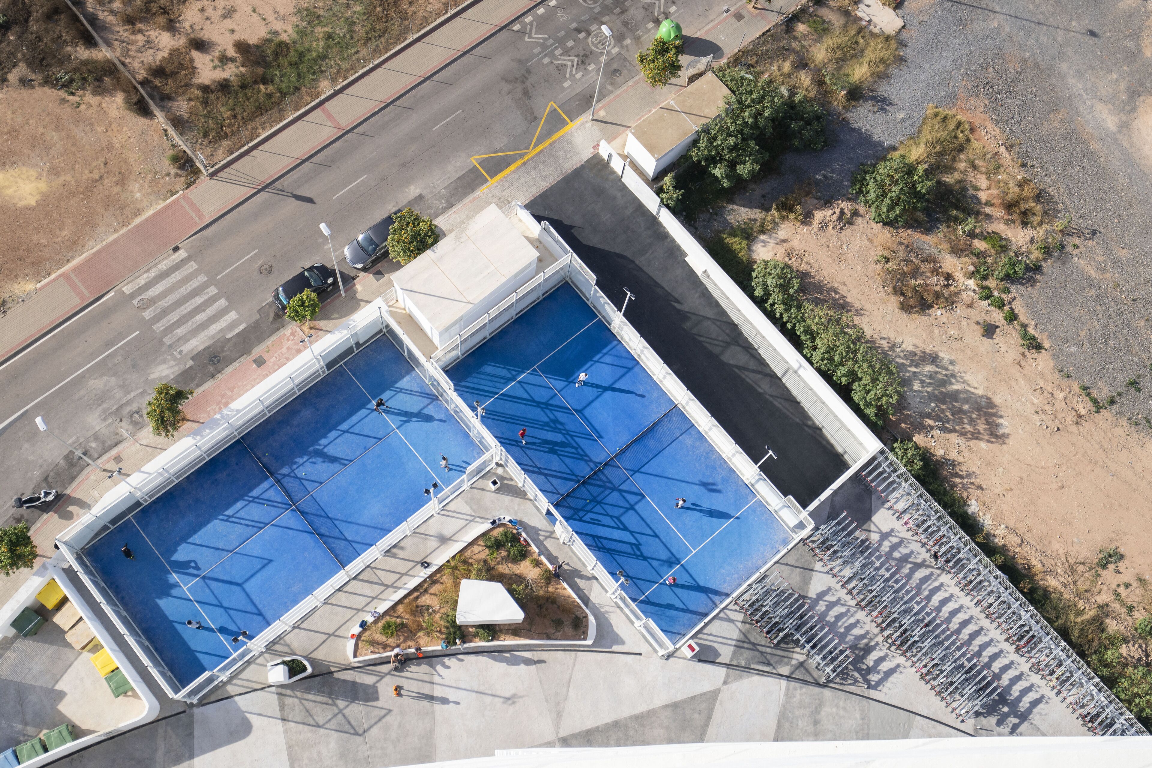 Vista aérea de un complejo de piscinas con varias albercas y una zona cubierta.