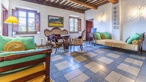A room with a checkered floor, wooden furniture, and a rustic ceiling. - Vacation Home in Camaiore with 4 bedrooms sleeps 8 (Camaiore)