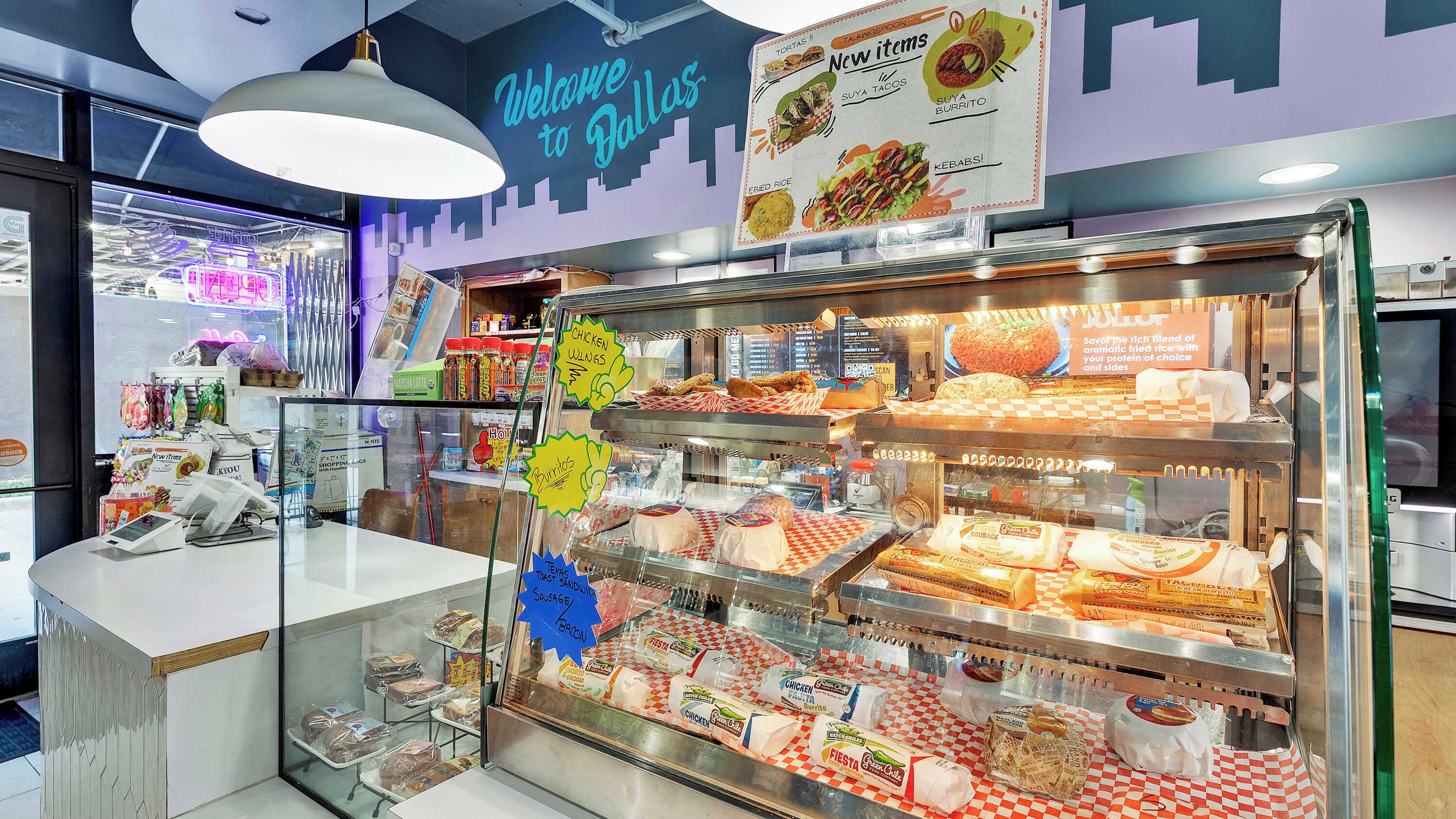 A food display case with various items like chicken, sausage, and bacon.