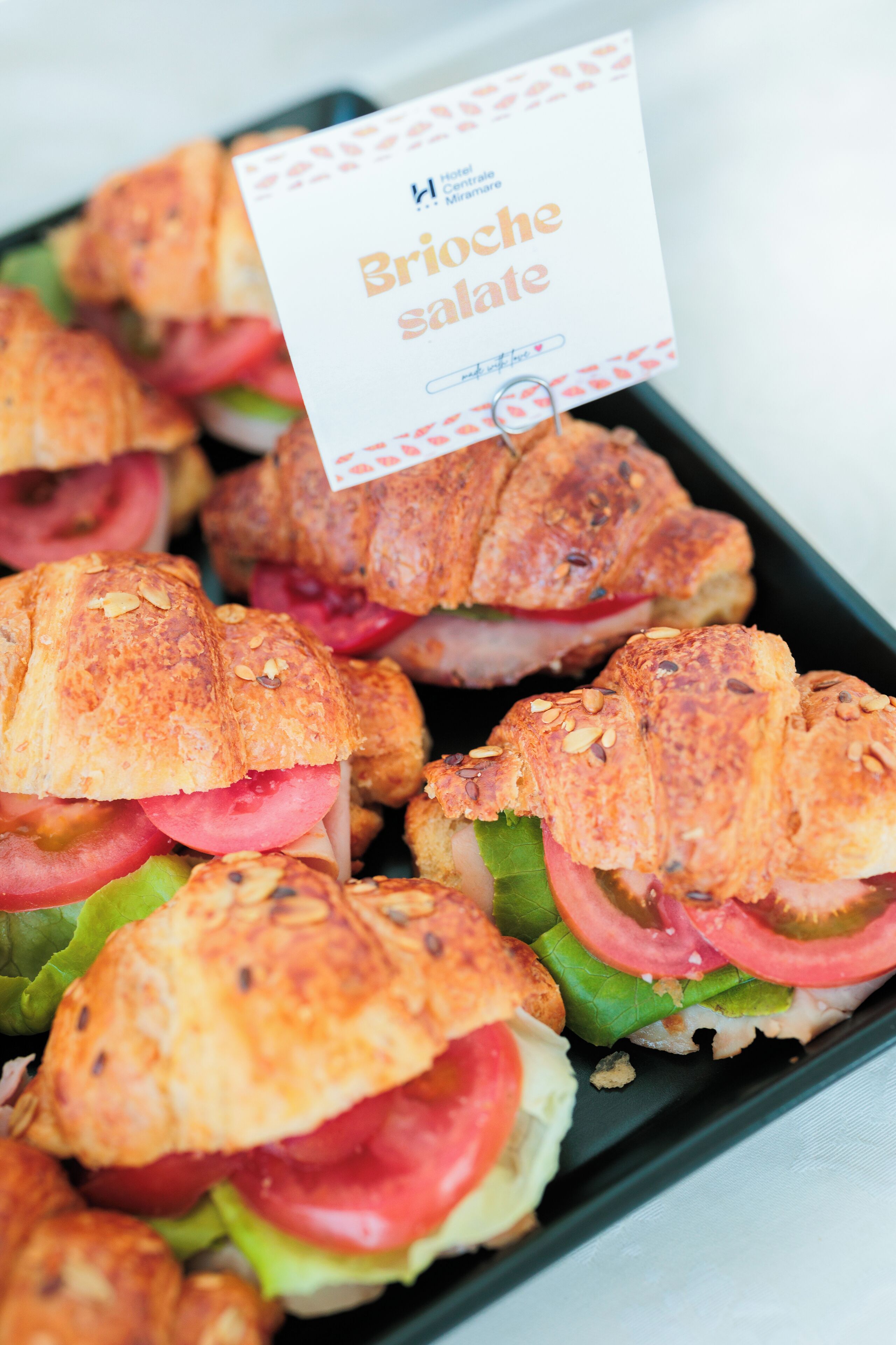 A tray of sandwiches with a label reading "Brioche salate."