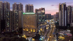 A high-rise building with a prominent sign reading "Wyndham Garden". - Wyndham Garden Foshan Jinshazhou (Guangzhou)