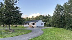 A single-story house with a front porch and a driveway leading to the entrance. - Minutes away from Presque Isle. 
On the ATV trail access and SNOWMOBILE Trail (Chapman)