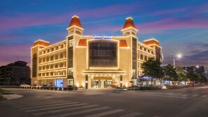 A large hotel with a prominent entrance, multiple floors, and a central atrium.