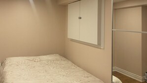 A bedroom with a bed, a wardrobe, and a mirror. - Lovely one bedroom unit  (Mississauga)