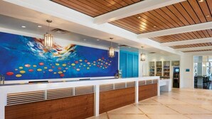 A reception area with a large mural, wooden ceiling, and a modern design. - Marriot's Harbour Lake 
2 Bedroom Villa (Orlando)