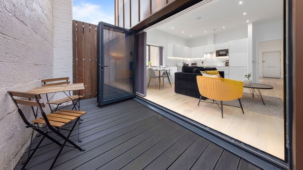A modern kitchen with white cabinets and a black countertop. - SERCASA - Appletree Court - Kingston (Kingston Upon Thames)