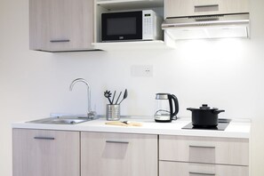 Fridge, microwave, stovetop, coffee/tea maker