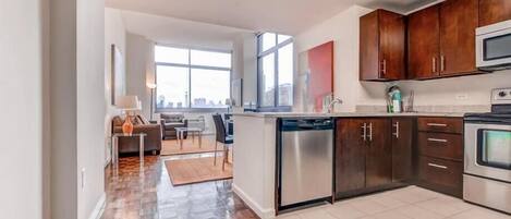A modern kitchen with wooden cabinets, a dishwasher, and a stove.
