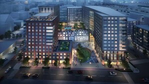 Un moderno complejo de edificios urbanos con varias estructuras altas, un patio central y calles aledañas.