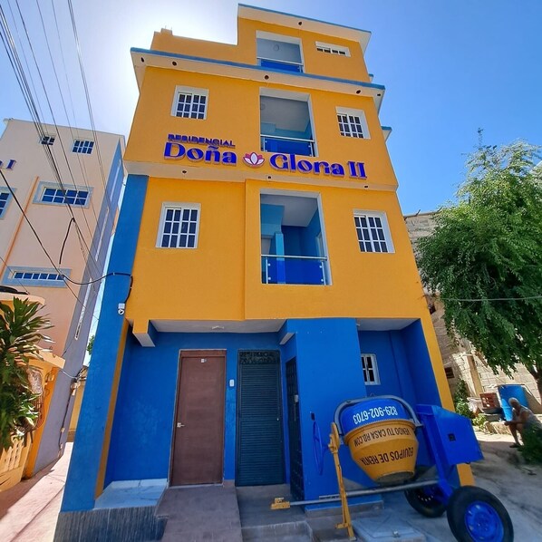 A multi-story building with a yellow and blue facade, labeled "Residencial Dona Clara II". - RESIDENCIAL DOÑA GLORIA III (Puerto Plata)
