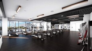 A modern gym with treadmills, elliptical machines, and weight equipment.