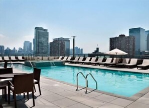 A heated pool - Modern 1BR | Full Kitchen | W/D |  NYC Views | by GLS (Jersey City)
